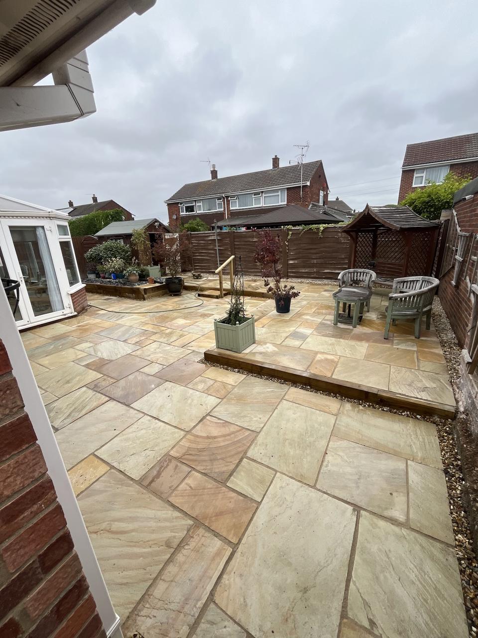 Finished sandstone patio with pergola and outdoor furniture, built by H.J.C Landscaping in Newark-on-Trent